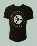 Black short sleeve t-shirt with white and orange letters that go around in a circle that says The Next Waltz Sound Recordings Since 2017 Austin, TX. In the center of the shirt there is a cream colored tape wheel with The Next Waltz logo in orange. The words circle around the tape reel.